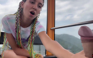 Playful chick jerks a random guy's cock off on a Ferris Wheel