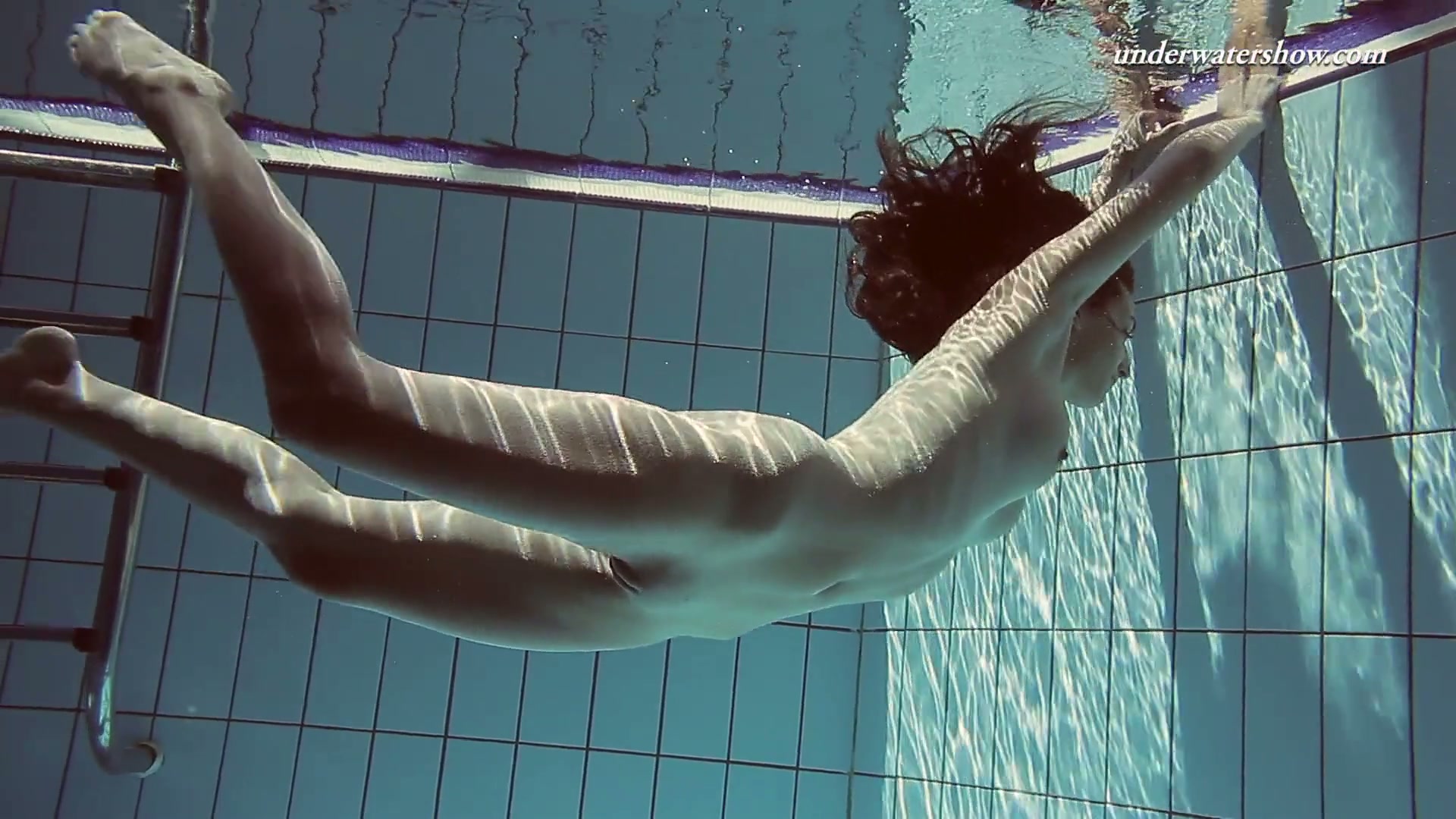 Gorgeous Sima swims naked in a pool exposing her beauty image pic